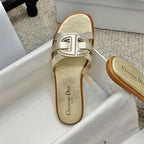 Dior metallic gold slide sandal with wide front strap and logo-style buckle