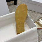 Dior gold sandal outsole with patterned grip marks and small symbol detailing