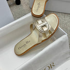 Dior gold slide sandals with branded footbed and interlocking front buckle