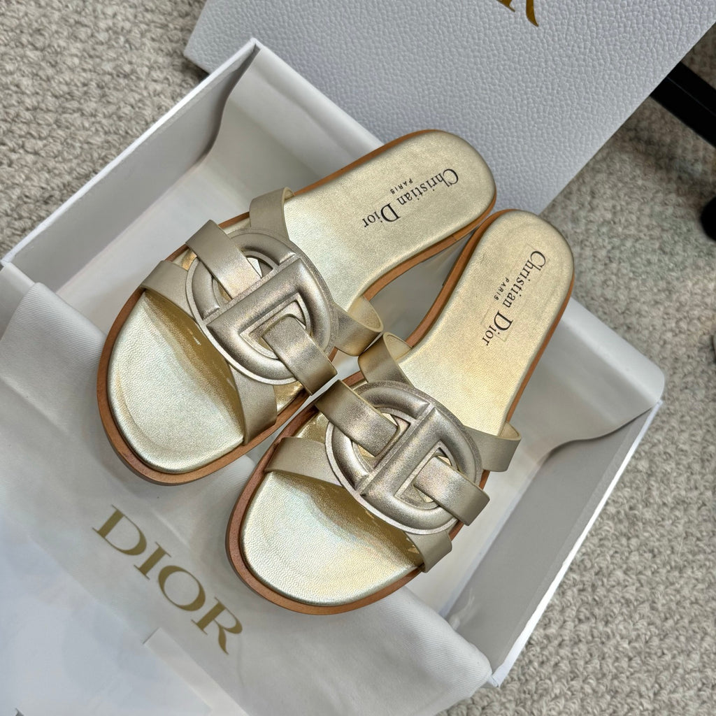 Dior gold slide sandals in box, featuring glossy strap and open-toe design
