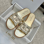 Dior gold slide sandals in box, featuring glossy strap and open-toe design