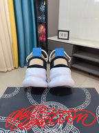 Pair of sneakers from the back view: white uppers, blue collar tabs, thick white soles
