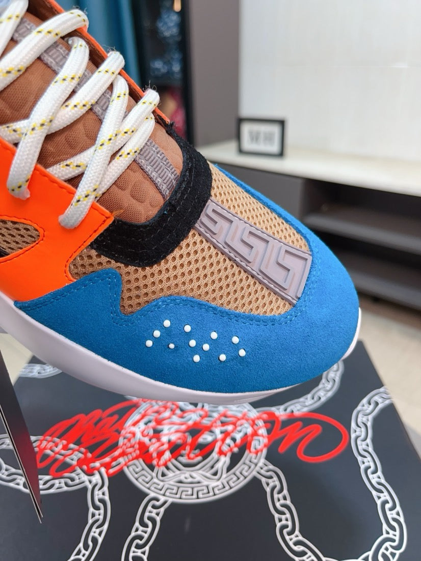 Close-up of sneaker toe and laces: blue suede, orange accents, mesh texture, white sole