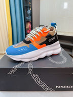 Low-top colorblock sneaker with white sole, orange laces, blue and black upper