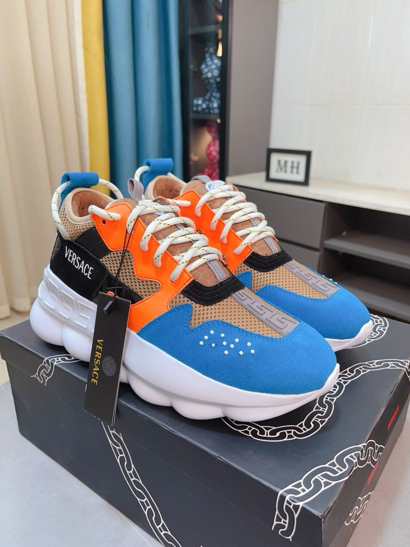 Colorblock low-top sneaker with white sole, orange laces, blue and black panels