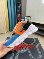 Runner-style sneaker with white sole, orange and blue upper, black heel panel
