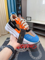 Sneaker with orange laces and colorblock upper, white sole, Versace tag