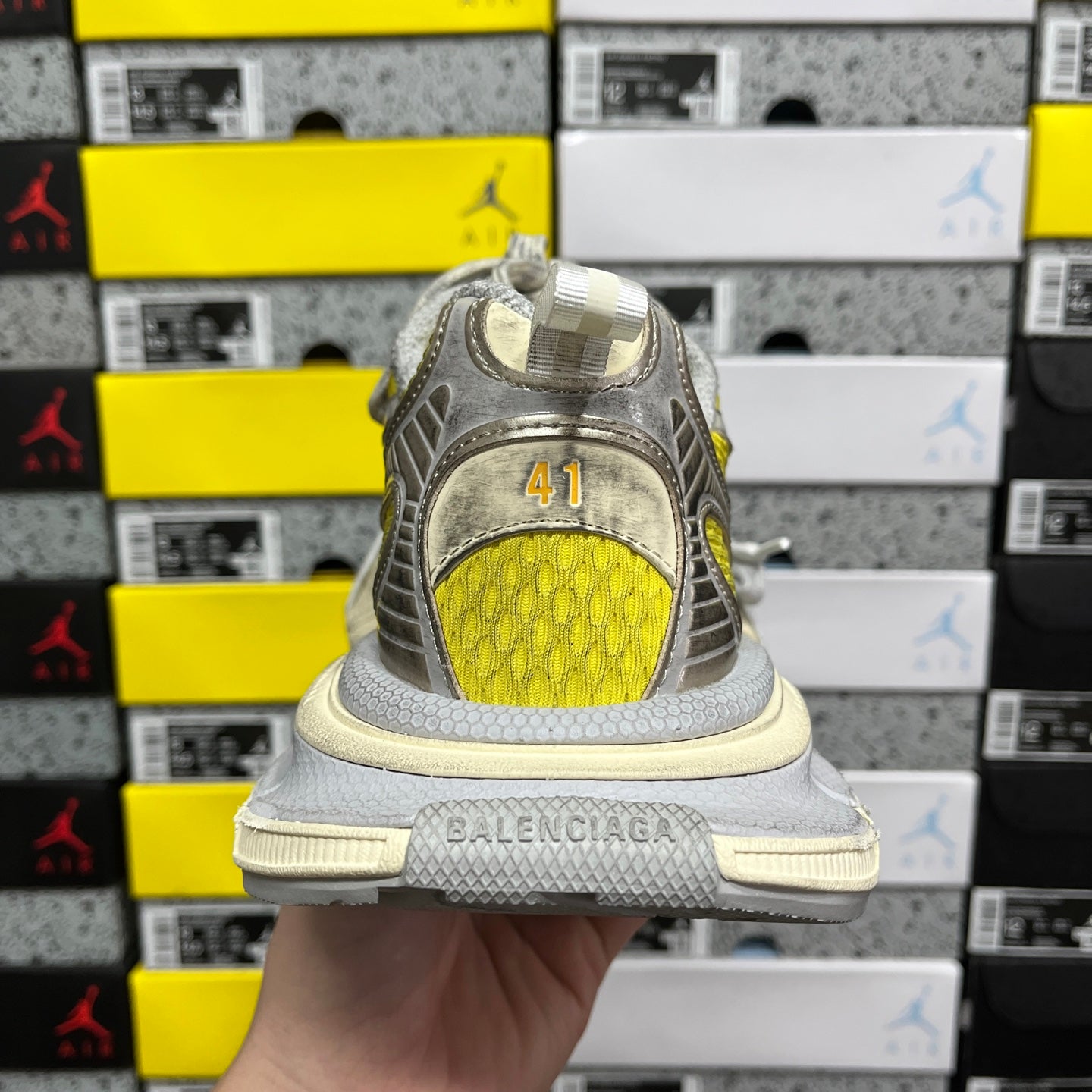 Balenciaga unisex sneakers rear view, yellow underlay with “BALENCIAGA” on sole