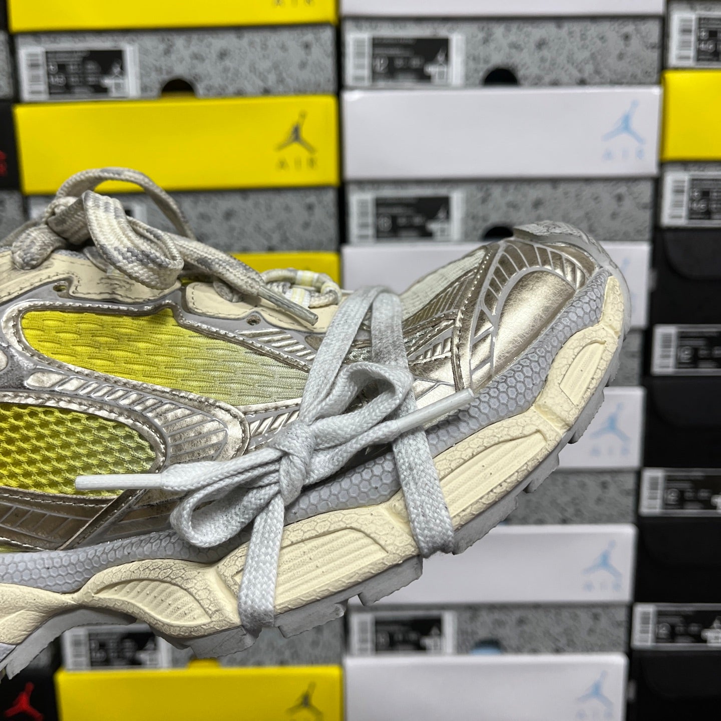 Balenciaga unisex sneaker side view, metallic gray with bright yellow panel and gray laces