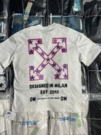 Off-White white T-shirt with large blue star X graphic and text "DESIGNED IN MILAN"