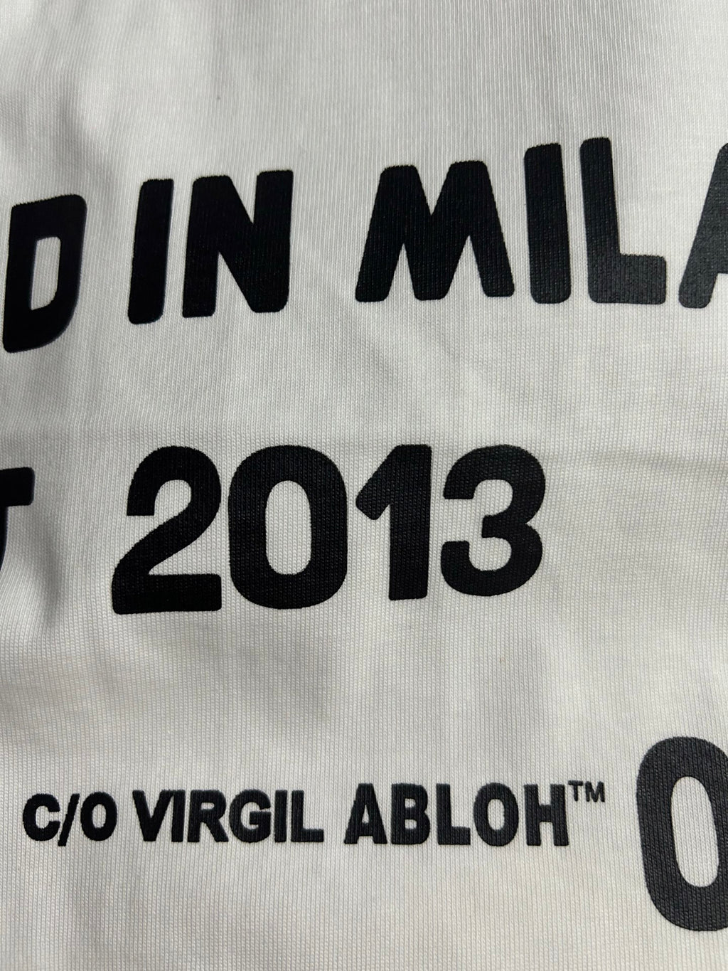 Off-White white T-shirt text detail: "DESIGNED IN MILAN EST 2013"