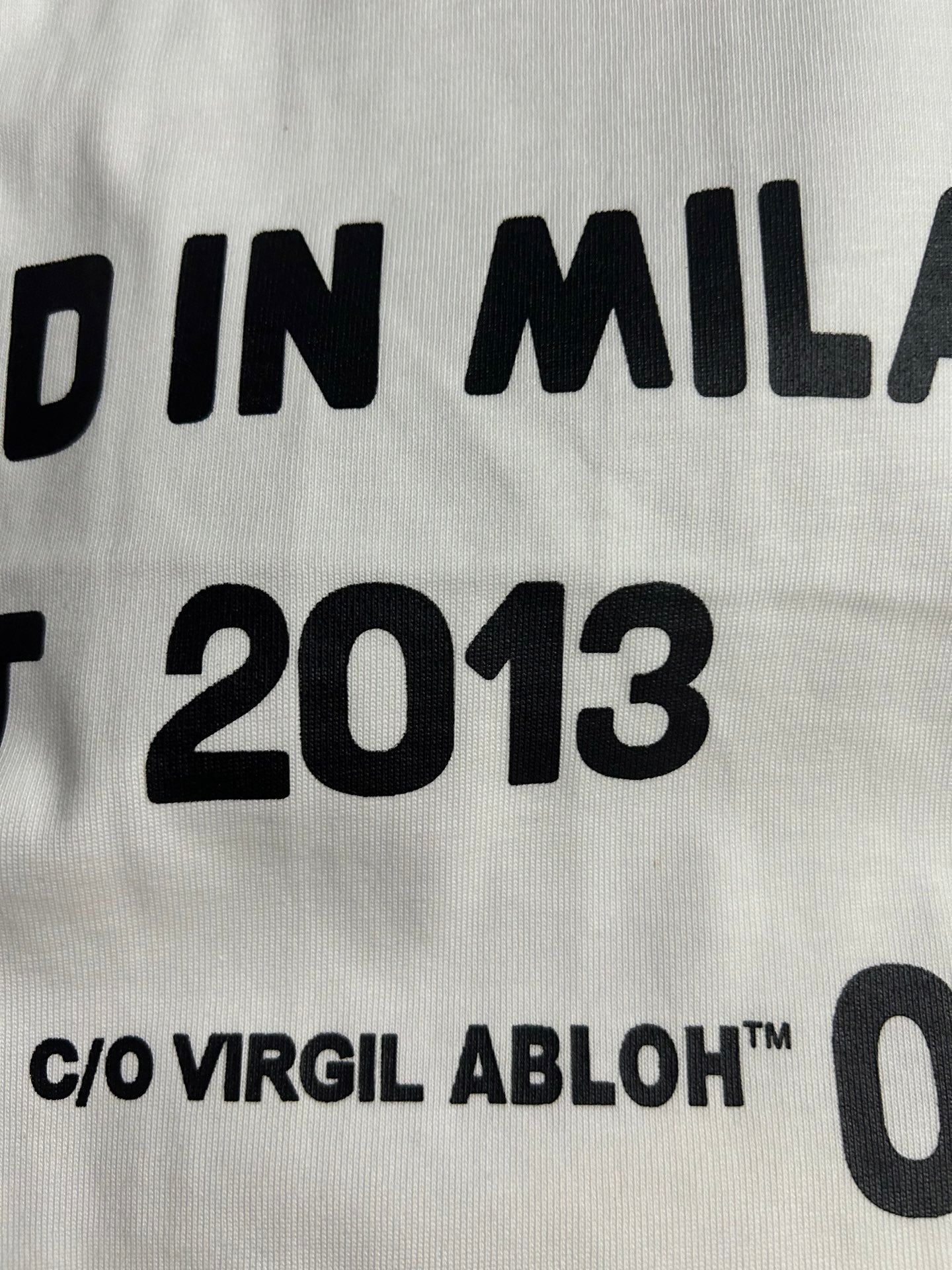 Off-White white T-shirt text detail: "DESIGNED IN MILAN EST 2013"