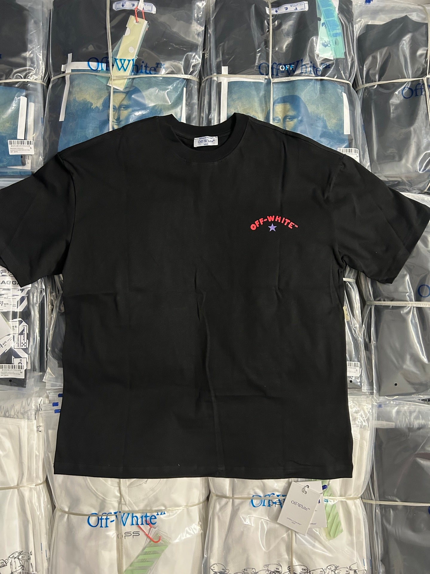 Black crewneck T-shirt with small red Off-White star logo on chest