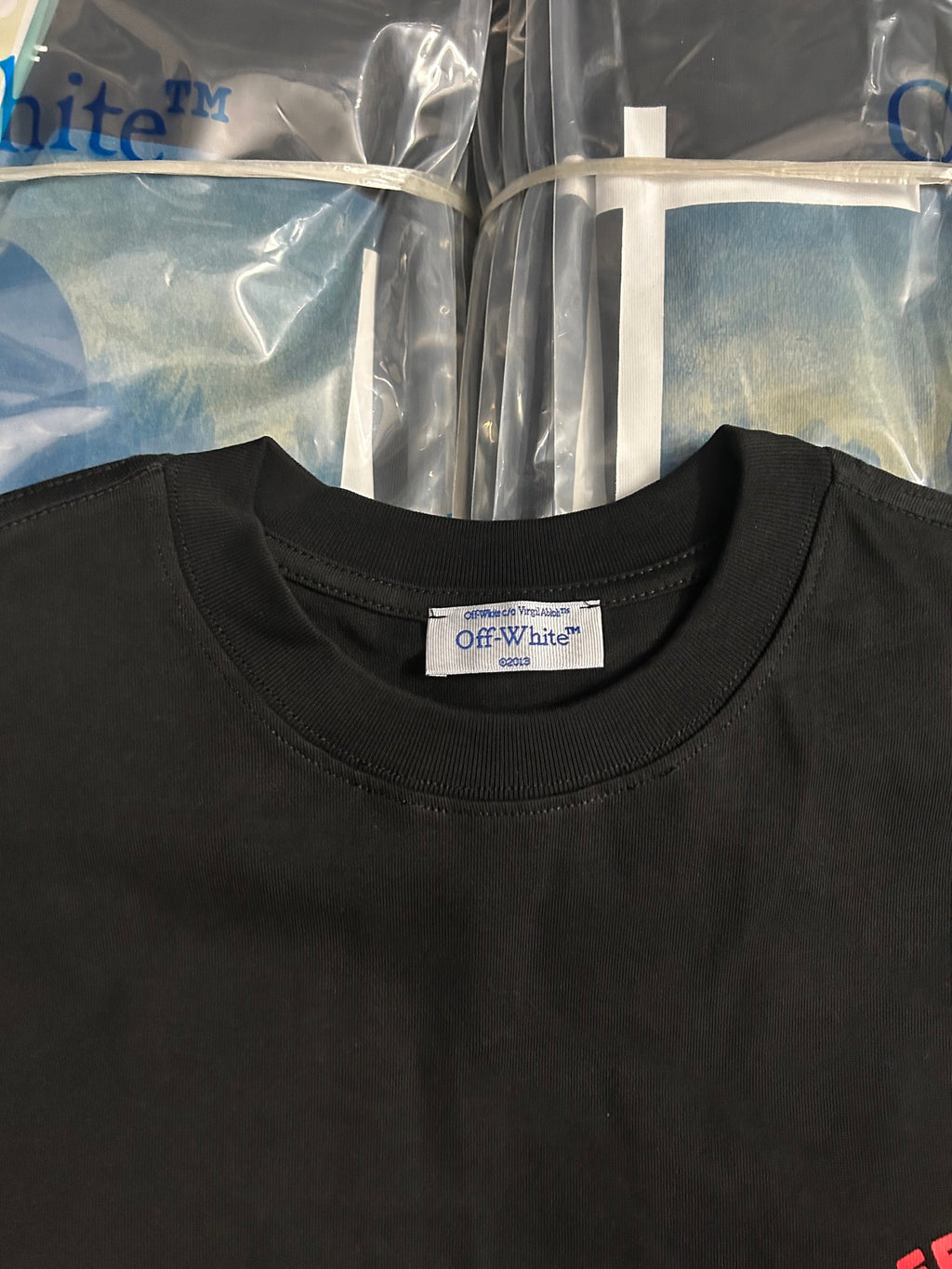 Black crewneck T-shirt neckline with Off-White size label