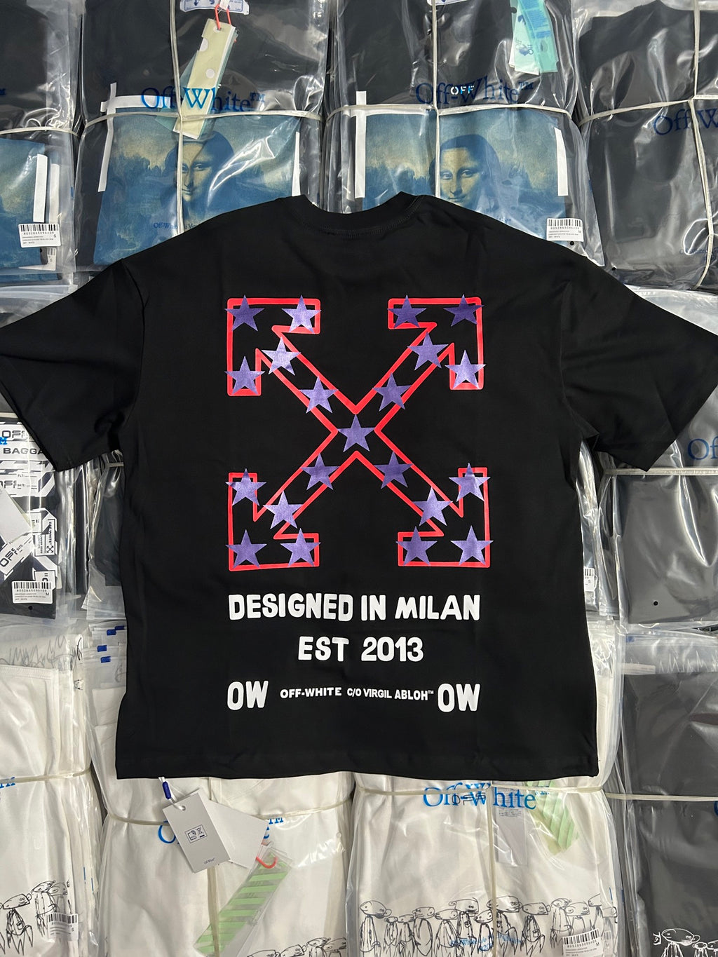 Black crewneck T-shirt with large red and white X graphic and 'DESIGNED IN MILAN' text