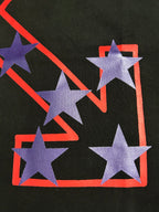 Black T-shirt graphic close-up of purple stars with red outlined frame