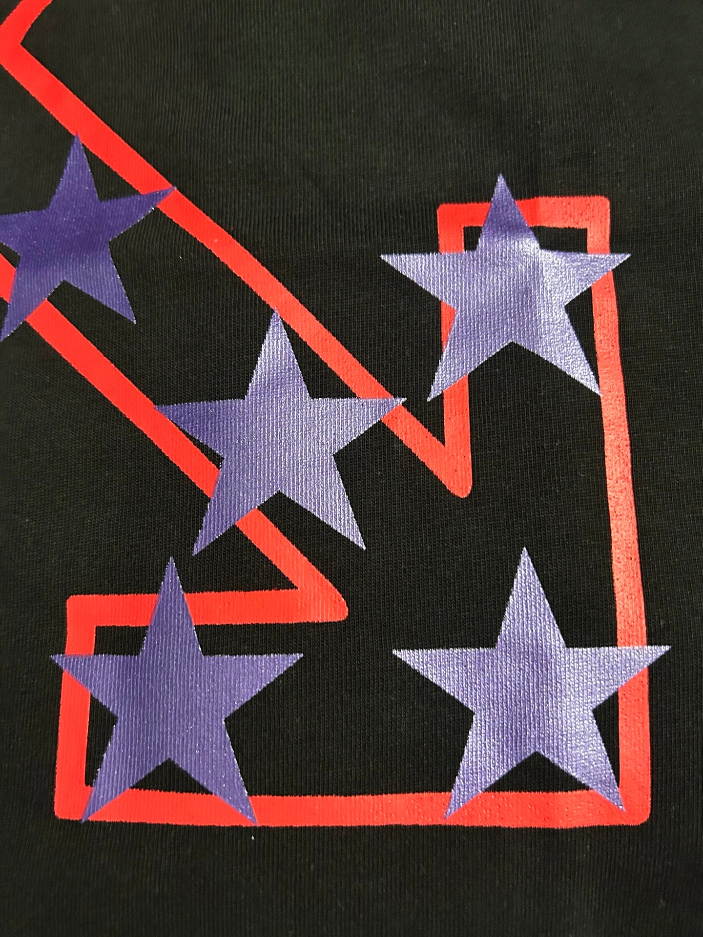 Black Off-White T-shirt close-up of purple star print on red outlined X