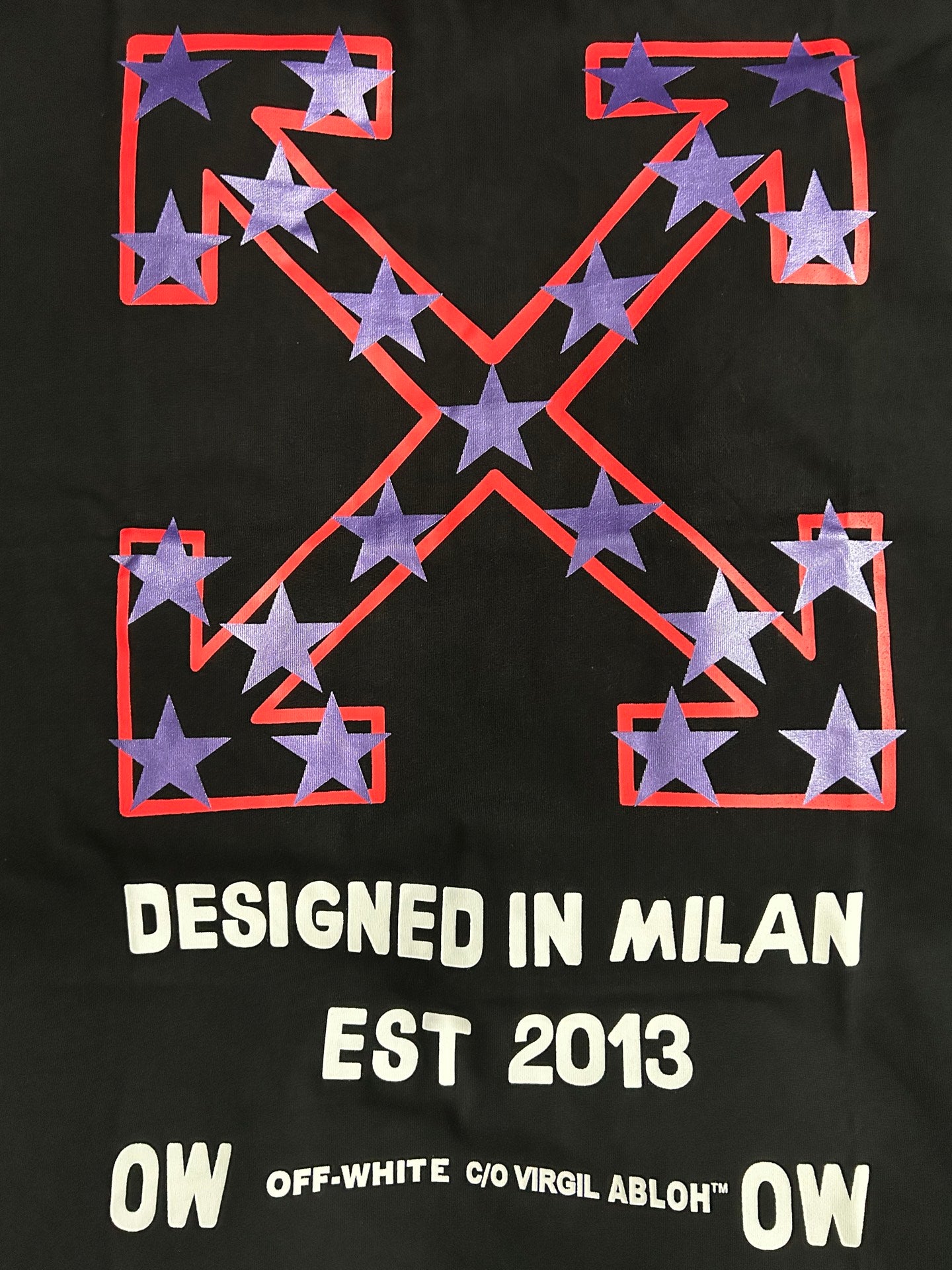 Black Off-White T-shirt front with red X graphic, stars, and 'DESIGNED IN MILAN'