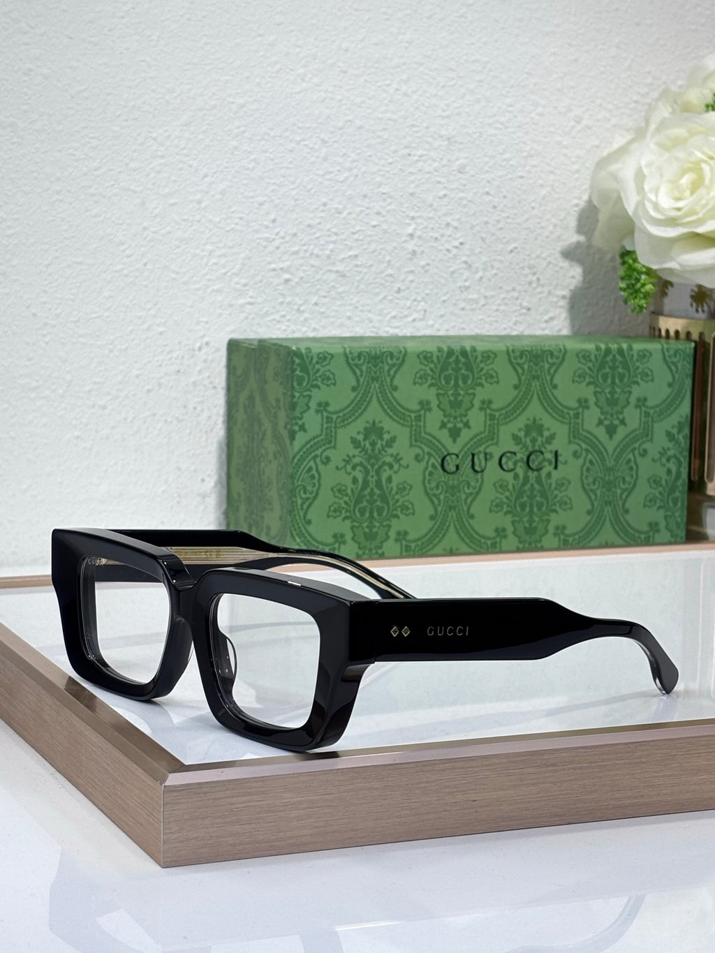 Gucci sunglasses with black frames and clear lenses, oversized square shape