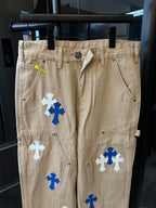Khaki pants with blue and white cross patches, zip front and belt loops