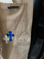 Beige denim cargo pants with pocket and blue and white cross patches