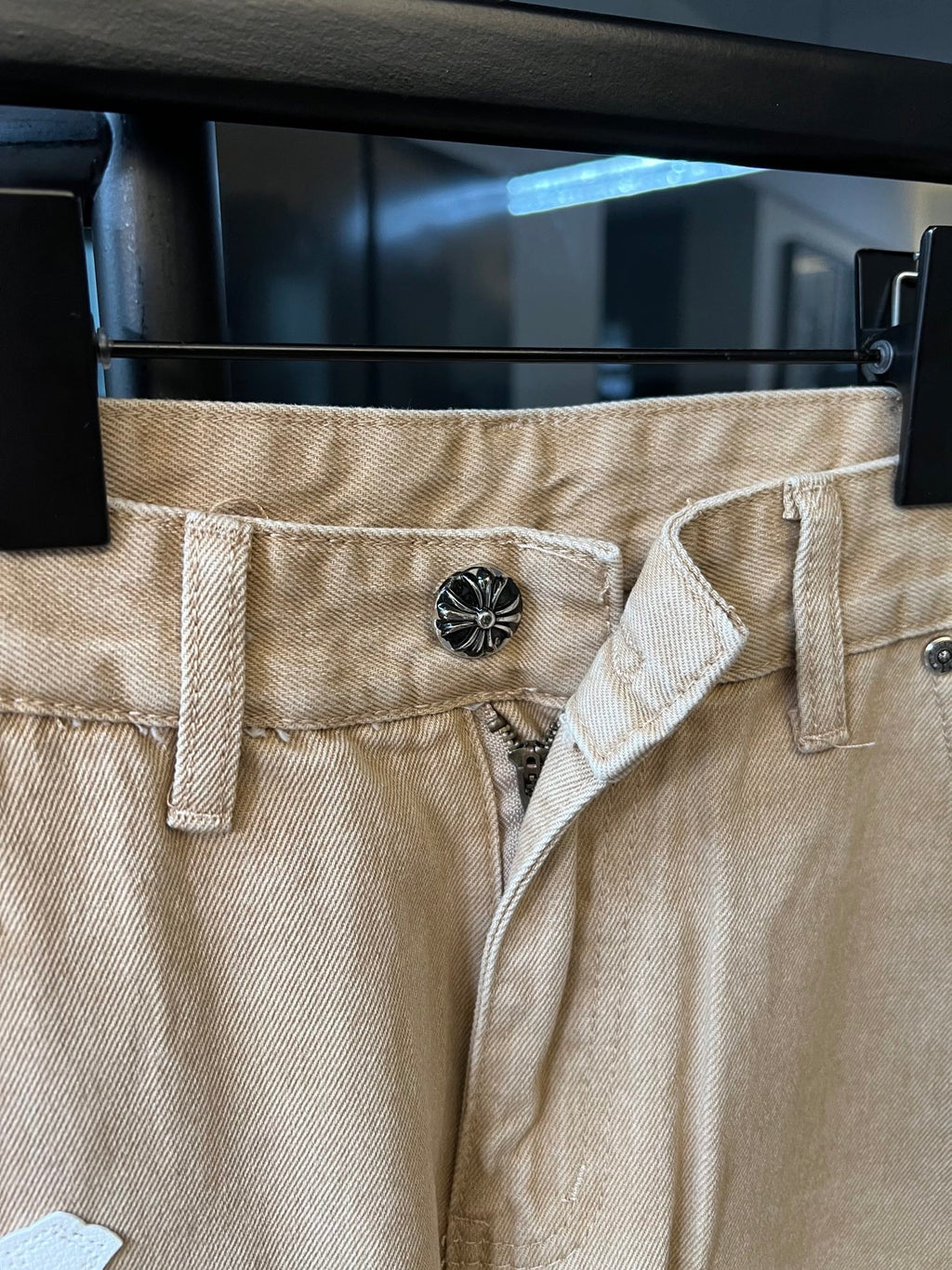 Khaki pants with decorative button waistband and fly opening, cross patch accents