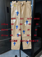 Khaki pants with scattered blue and white cross patches and visible seam markings