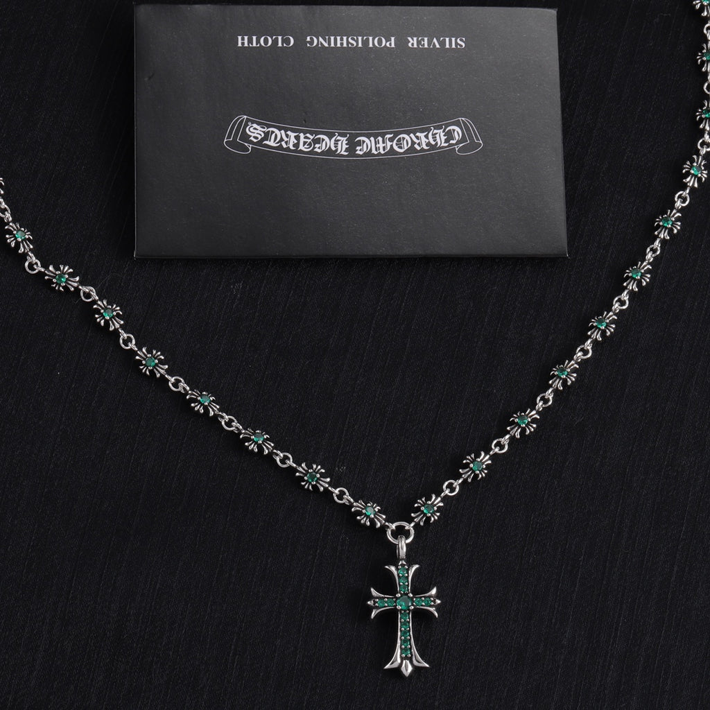 Silver cross pendant necklace with teal-green stone flower bead links