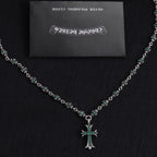 Silver cross pendant necklace with teal-green stone flower bead links
