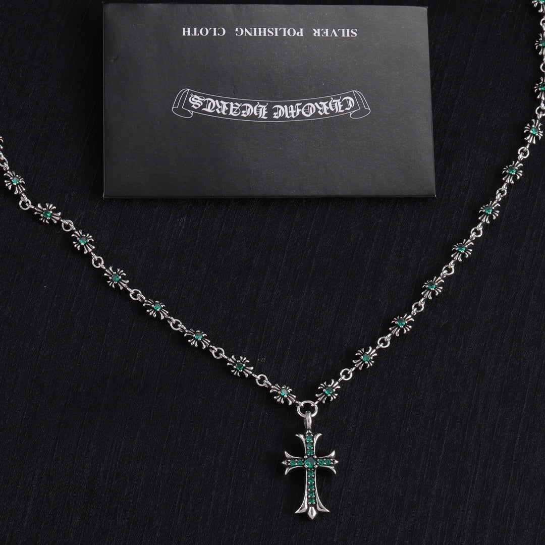 Silver cross pendant necklace with teal-green stone flower bead links