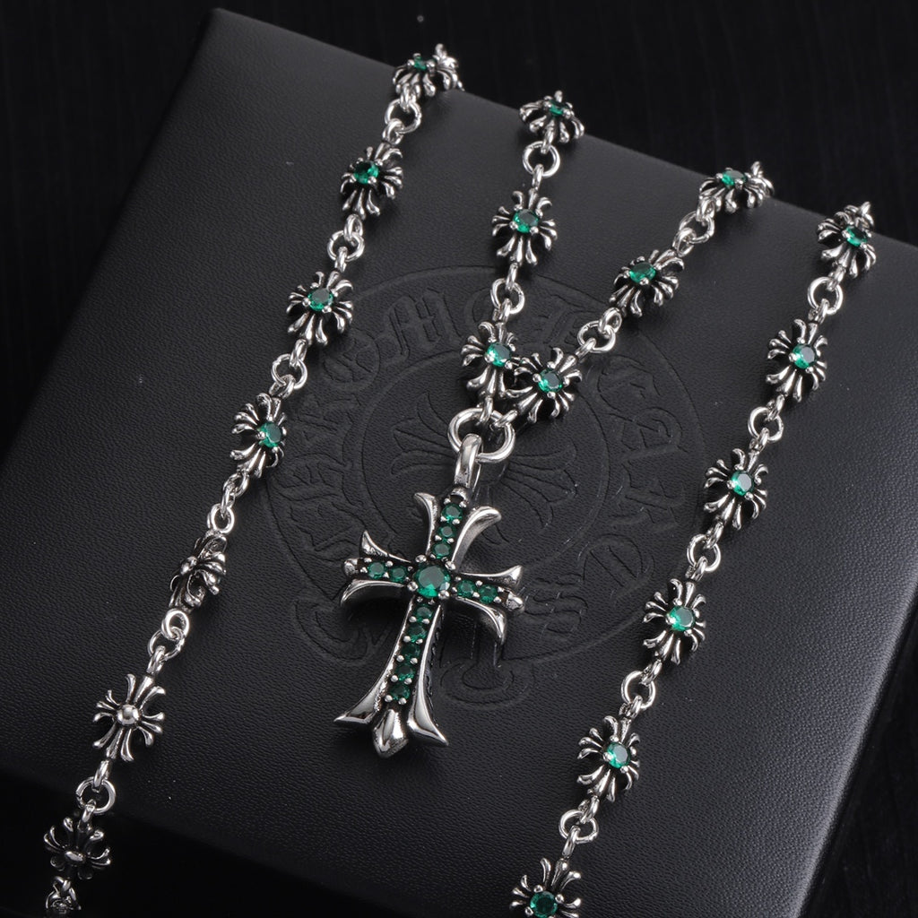 Silver cross pendant necklace with teal-green stone flower accents