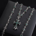 Silver cross pendant necklace with teal-green stone flower accents