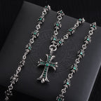 Silver cross pendant necklace with teal-green stone flower accents