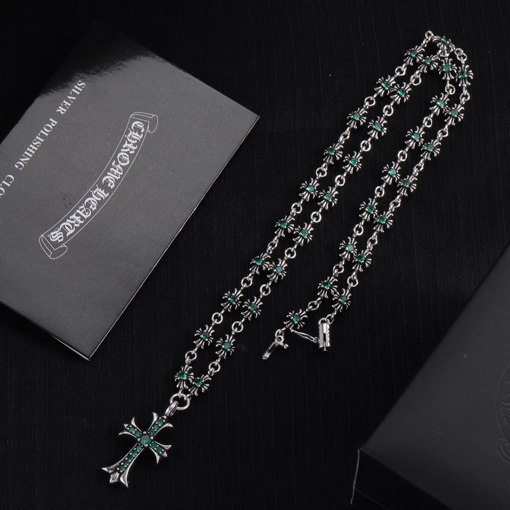 Silver cross pendant necklace with teal-green flower motif links