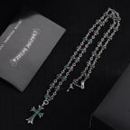 Silver cross pendant necklace with teal-green flower motif links