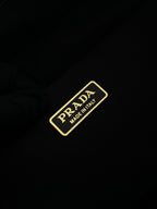 Prada nylon label patch reading 'Made in Italy' on dark fabric