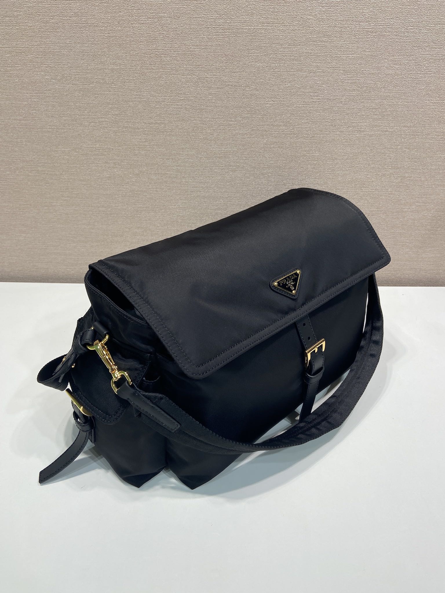 Prada nylon messenger bag with flap, dark navy and gold-tone closure