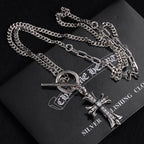 Silver-tone cross pendant necklace with oval ring clasp and gem accents