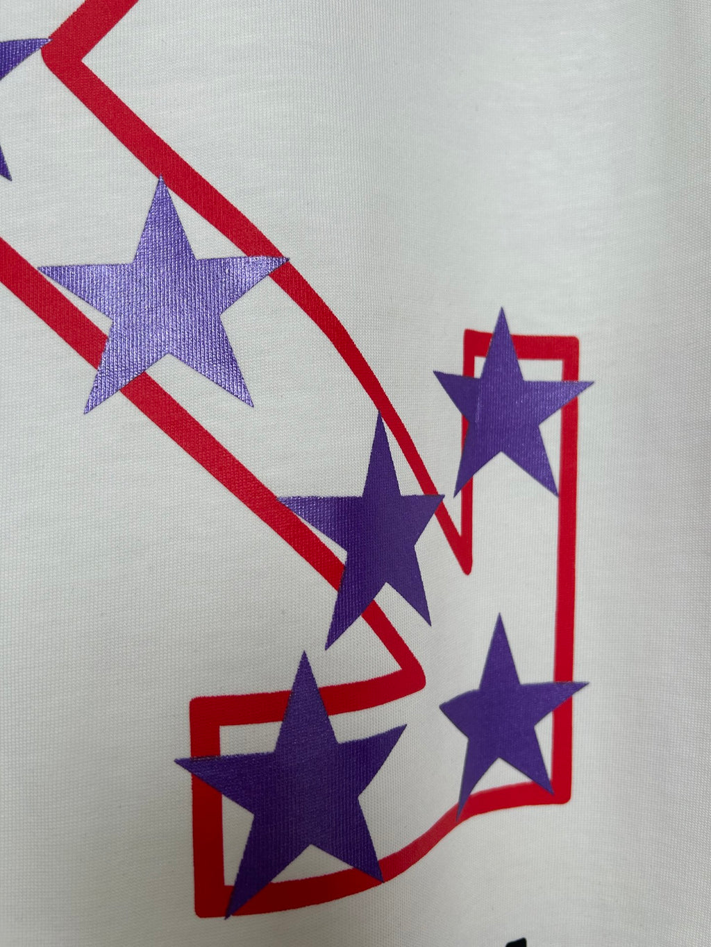 Off-White T-shirt close-up of purple stars over red and blue outlined shapes