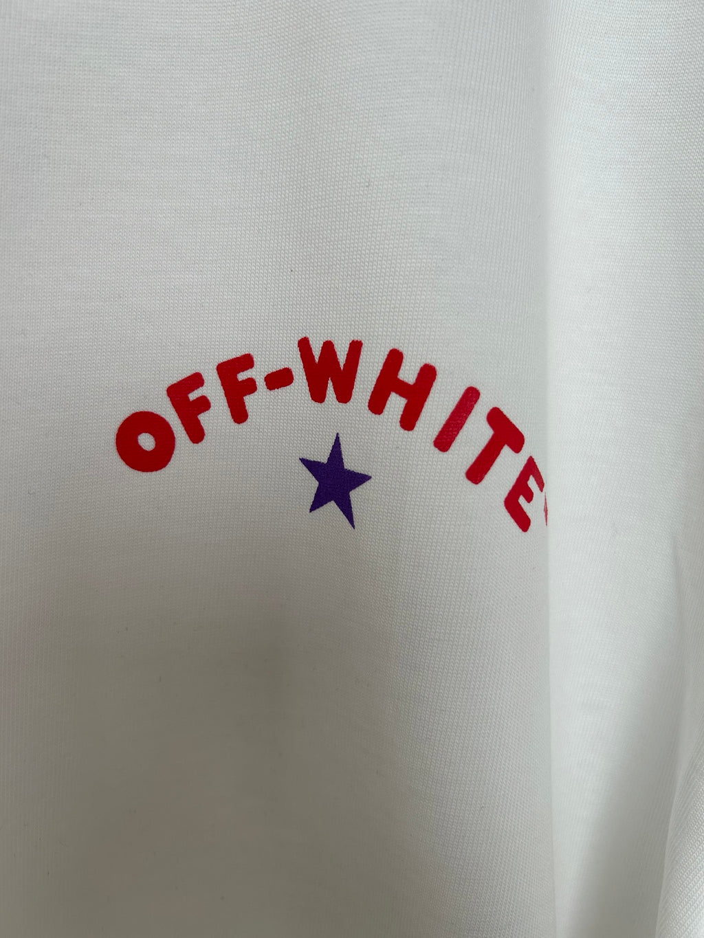 Off-White T-shirt graphic close-up with arched OFF-WHITE lettering and blue star