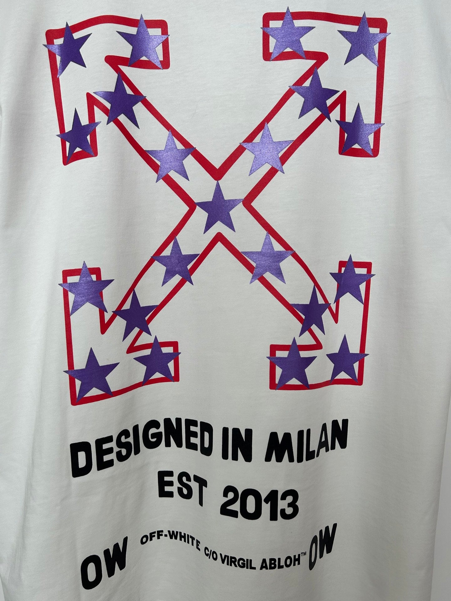 Off-White T-shirt front graphic with star-filled X motif and "DESIGNED IN MILAN" text