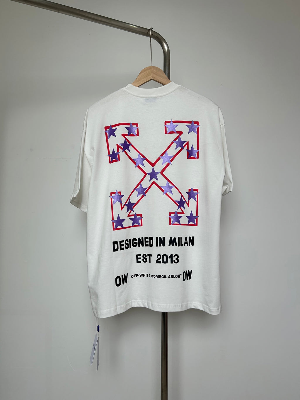Off-White T-shirt with large front graphic, stars and text "DESIGNED IN MILAN"