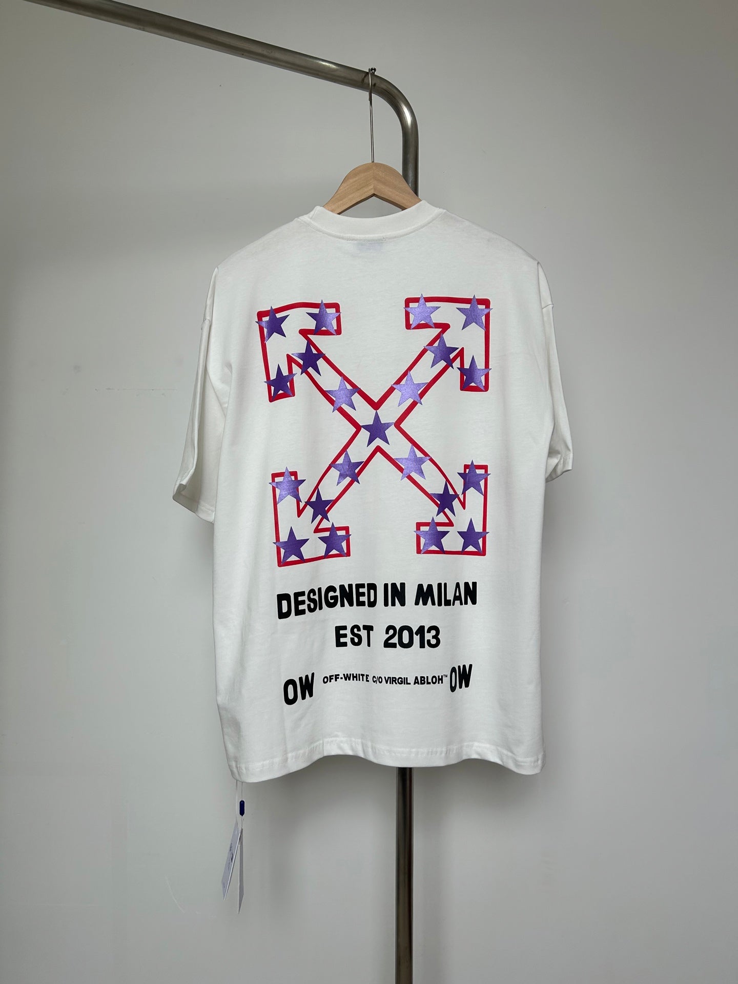 Off-White T-shirt with large front graphic, stars and text "DESIGNED IN MILAN"