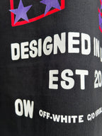 Off-White dark T-shirt close-up of white text “DESIGNED IN EST 2013” and OW branding.