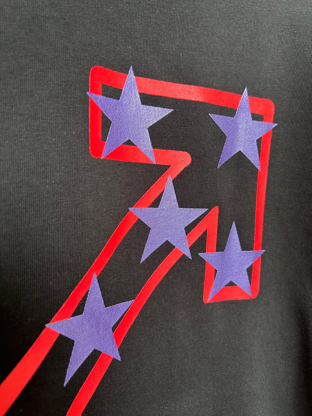 Off-White dark T-shirt with purple star graphic and red outline on the front.