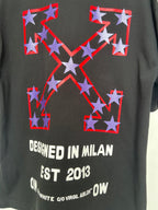 Off-White dark T-shirt with large star emblem and white text: “DESIGNED IN MILAN EST 2013”.