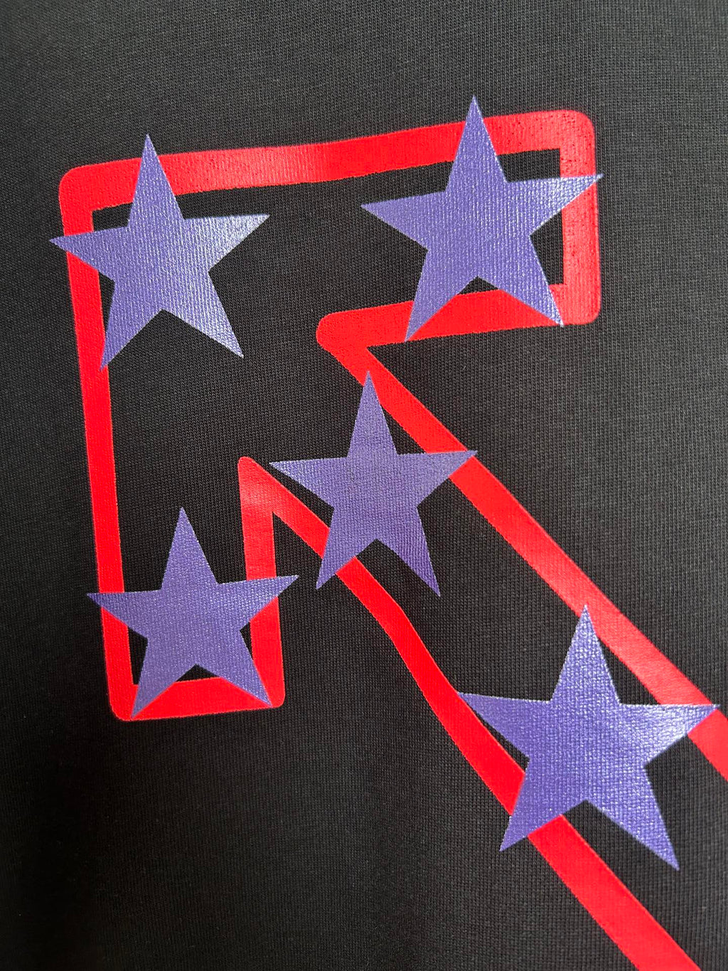 Off-White dark T-shirt featuring large purple star graphic with red-outlined shapes.
