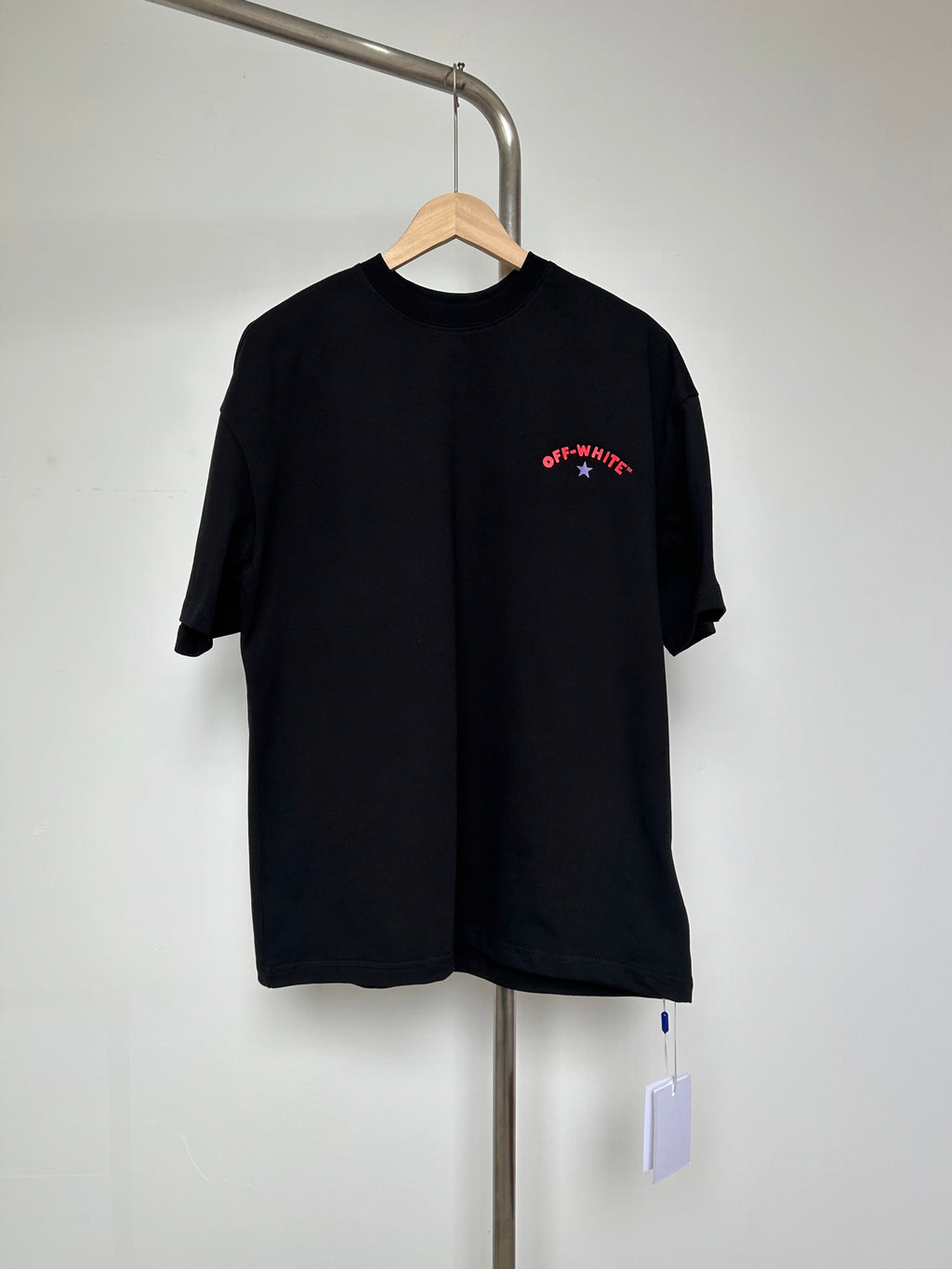 Off-White graphic T-shirt in dark with red logo print on chest.