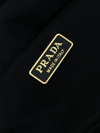 Prada made in Italy label on dark navy fabric with gold border