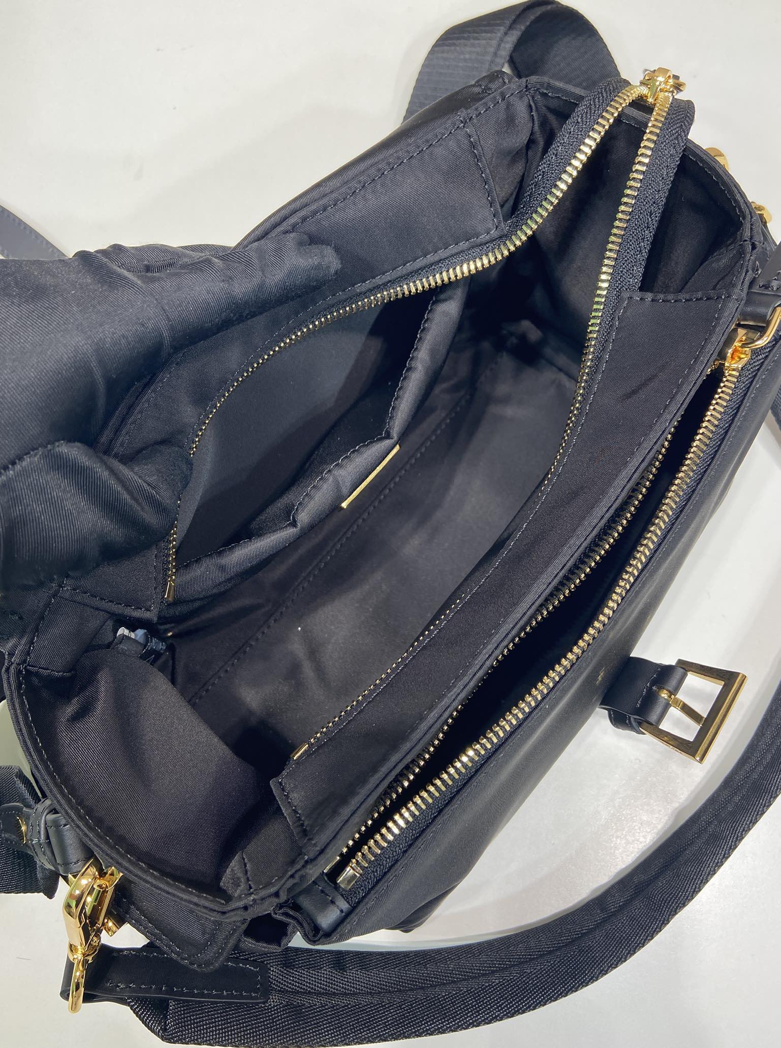 Prada crossbody bag interior, dark navy with zip compartments and gold chain trim